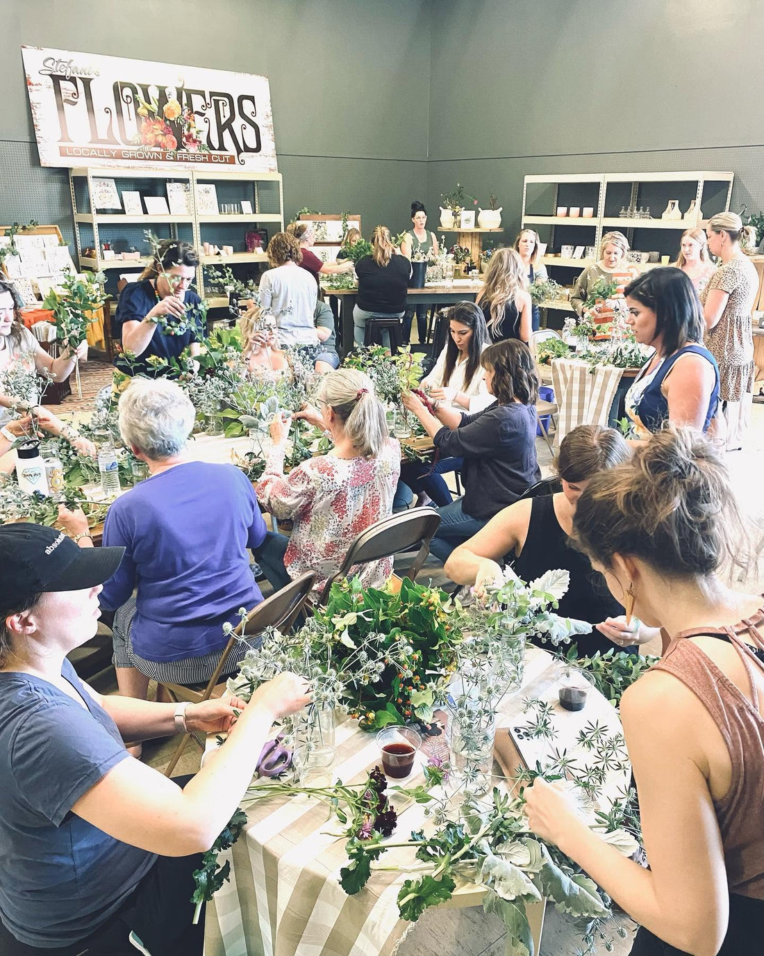 Guests creating flower arrangements during a class at 21 Petals