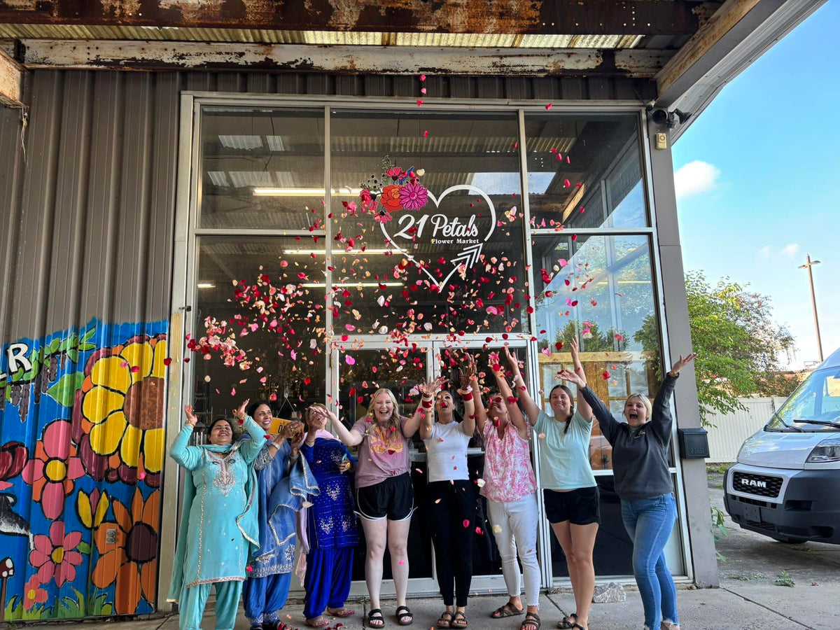 21 Petals team tossing flower petals outside the Lafayette flower market