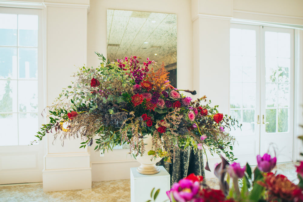 Floral urn with red and purple flowers by SoBro by 21 Petals at Ritz Charles in Carmel.