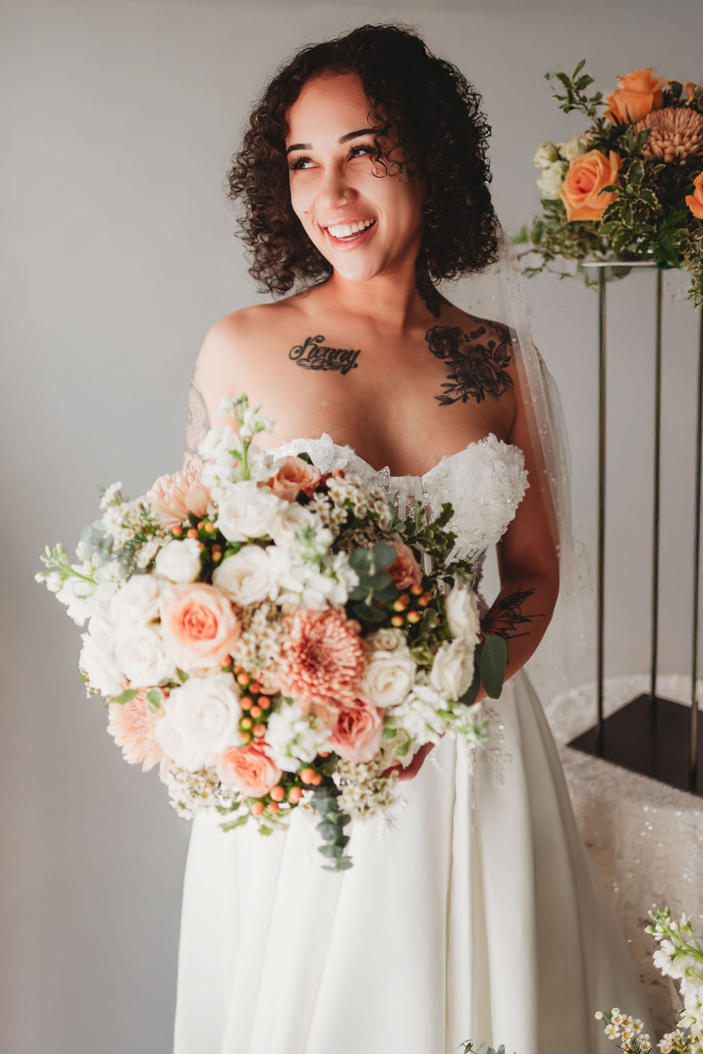 Bride holding a lush peach wedding bouquet