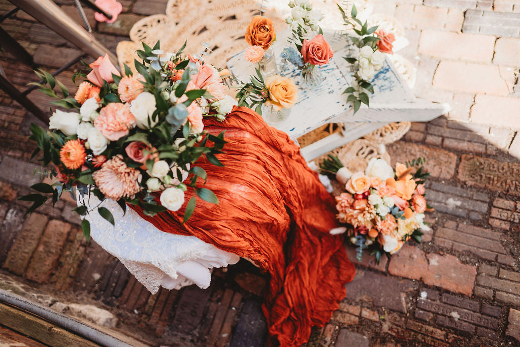 Peach wedding bouquets and floral details styled on vintage furniture