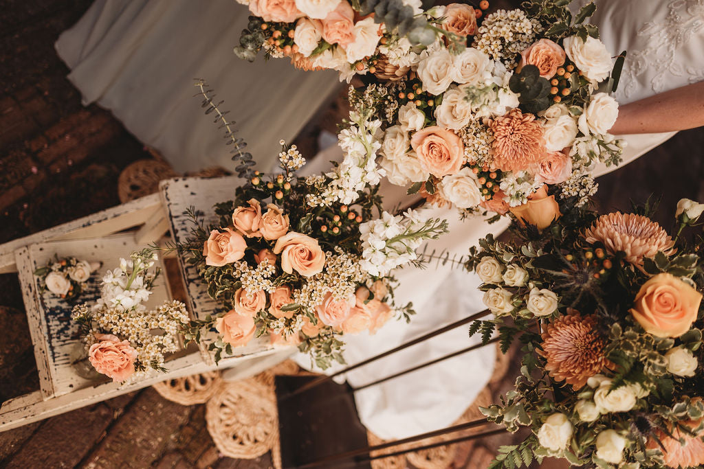 Overhead view of coordinated peach wedding flowers