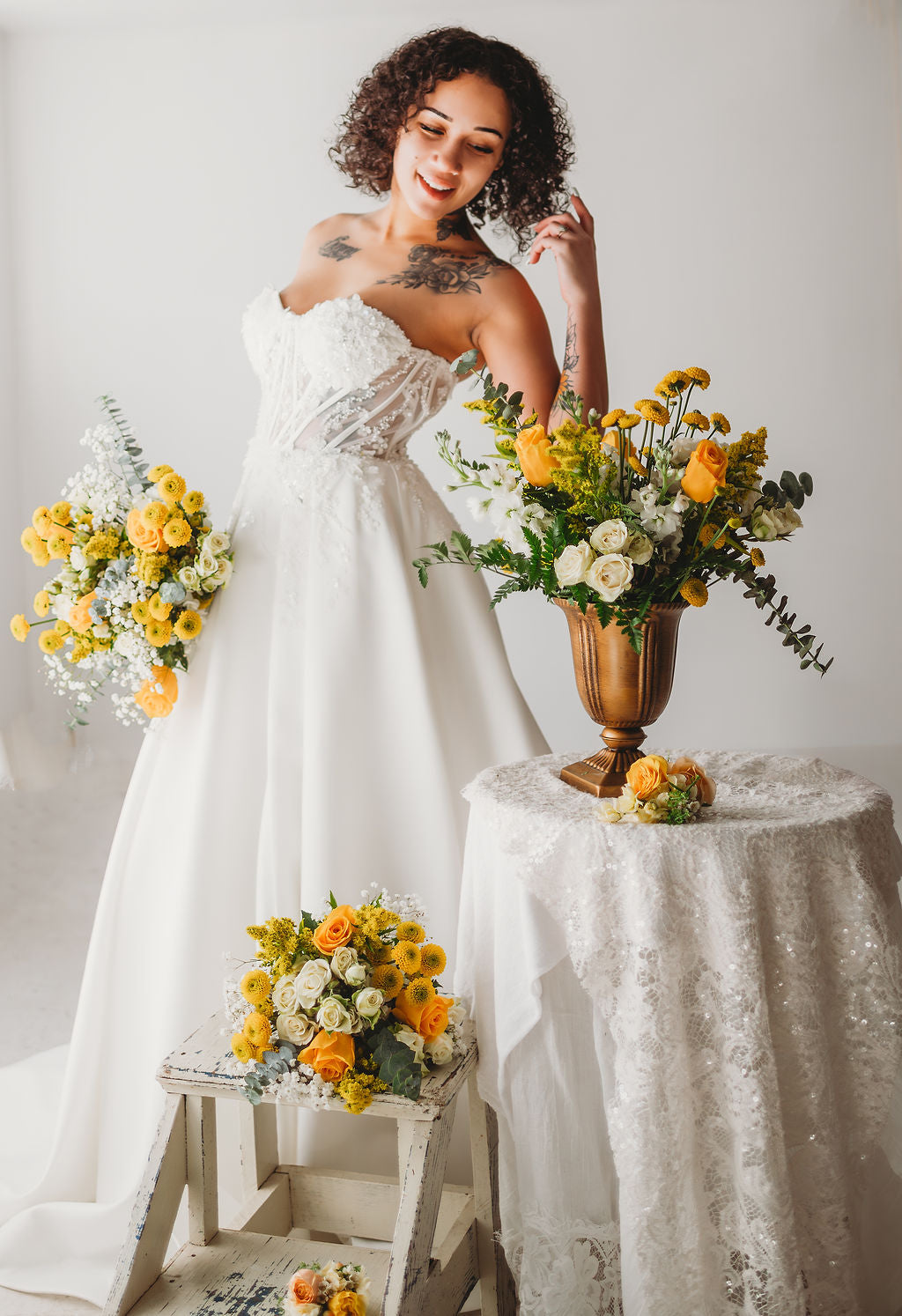 Bride with yellow wedding bouquets and floral centerpiece